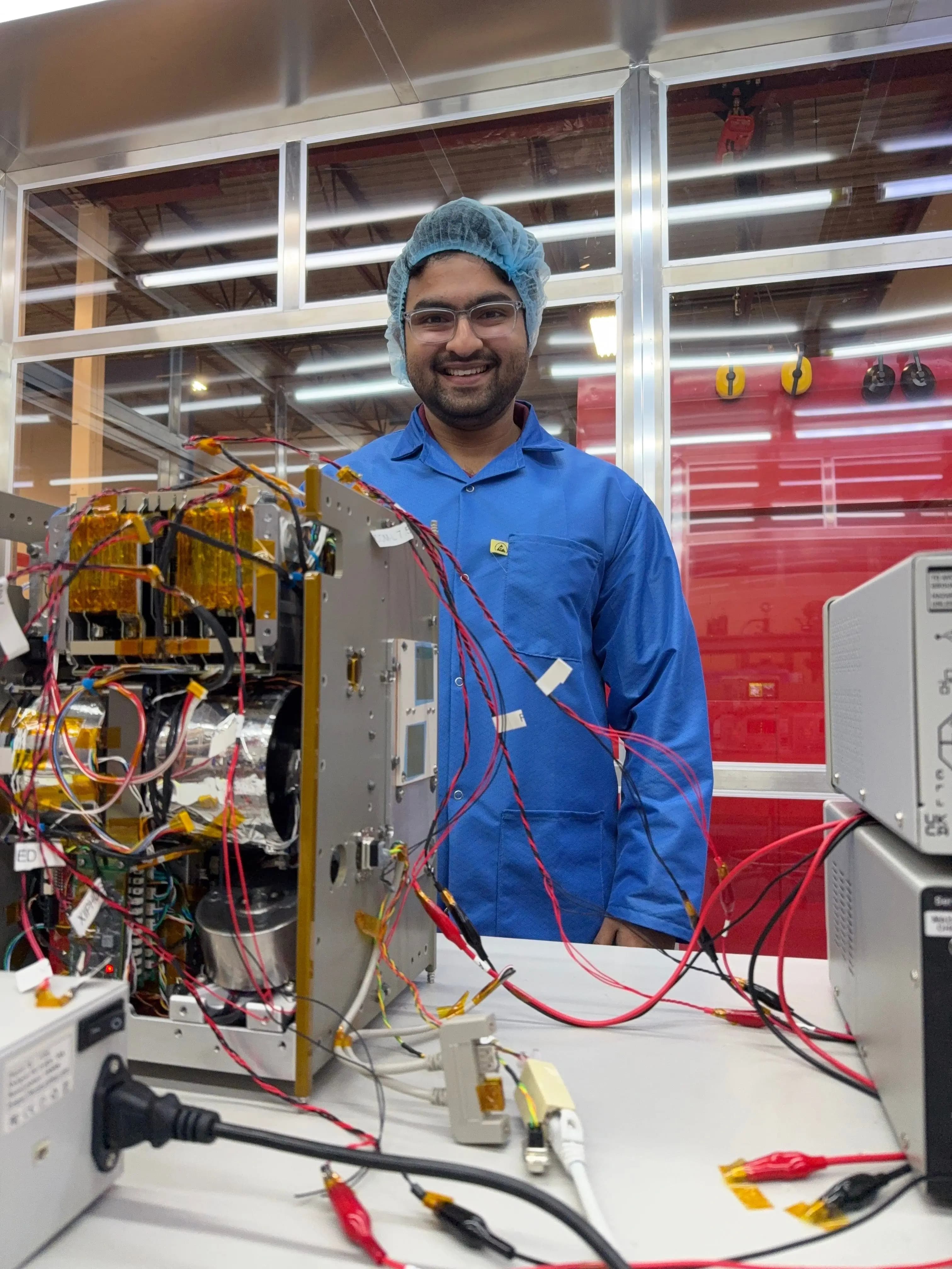 Mayukh Bagchi with InspireSAT flight hardware in cleanroom